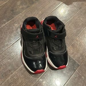 black and red jordan 11’s